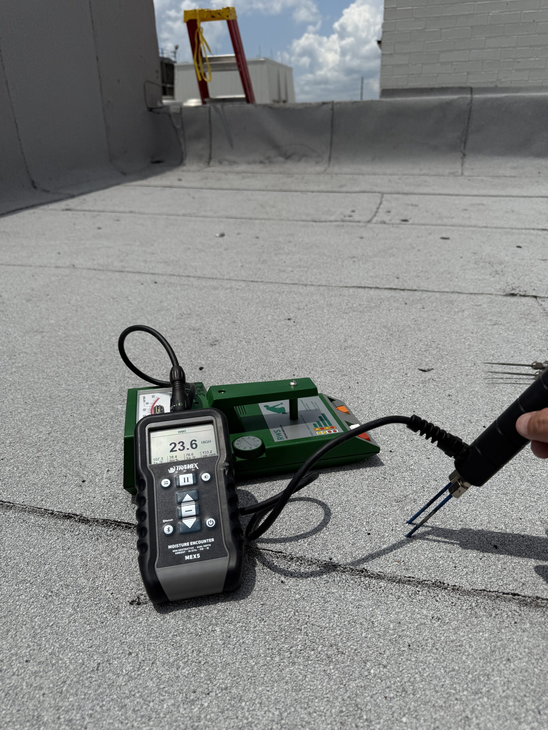 Commercial flat roof with technician scanning using Roof MRI