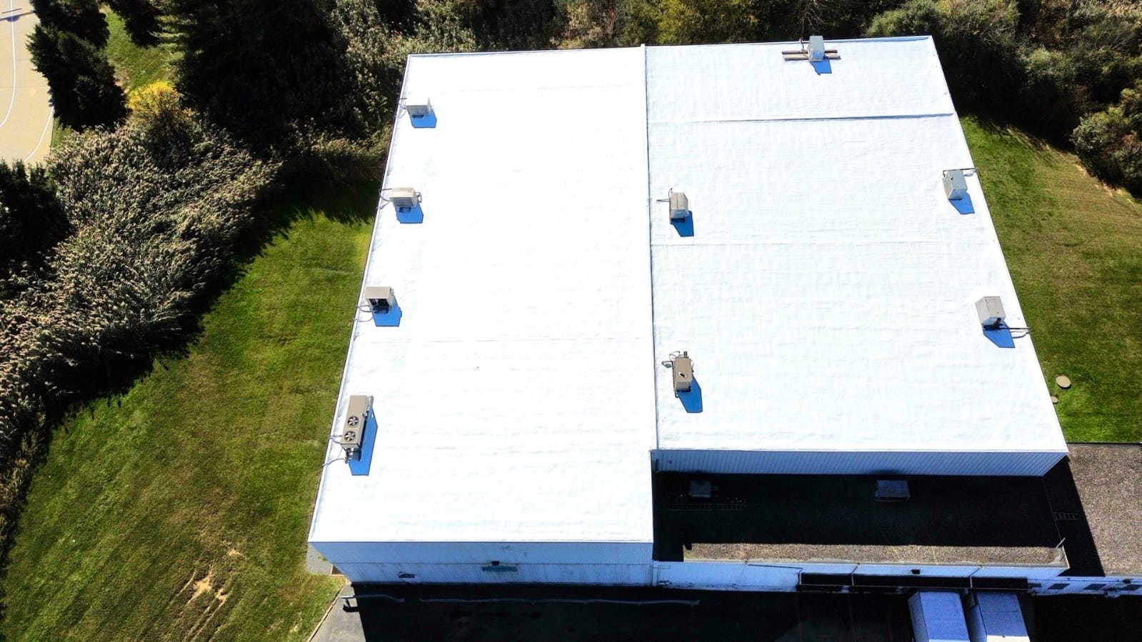 Membrane restoration with affinity top coat commercial building