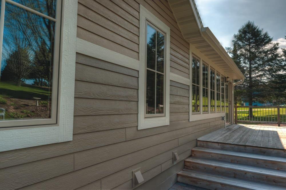 Traditional wood siding with natural grain finish on a cozy residential house, offering a rustic and warm exterior look.